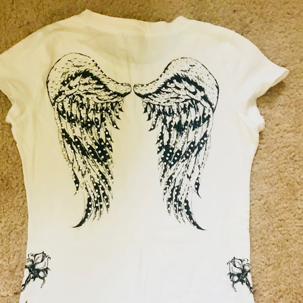 White top with angel wings on the back